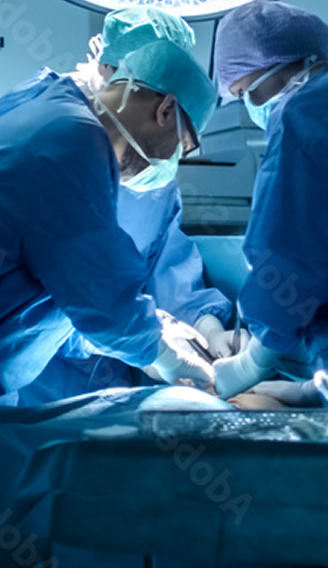 Surgical team wearing blue scrubs, surgical caps, and masks performing an operation in an operating room.